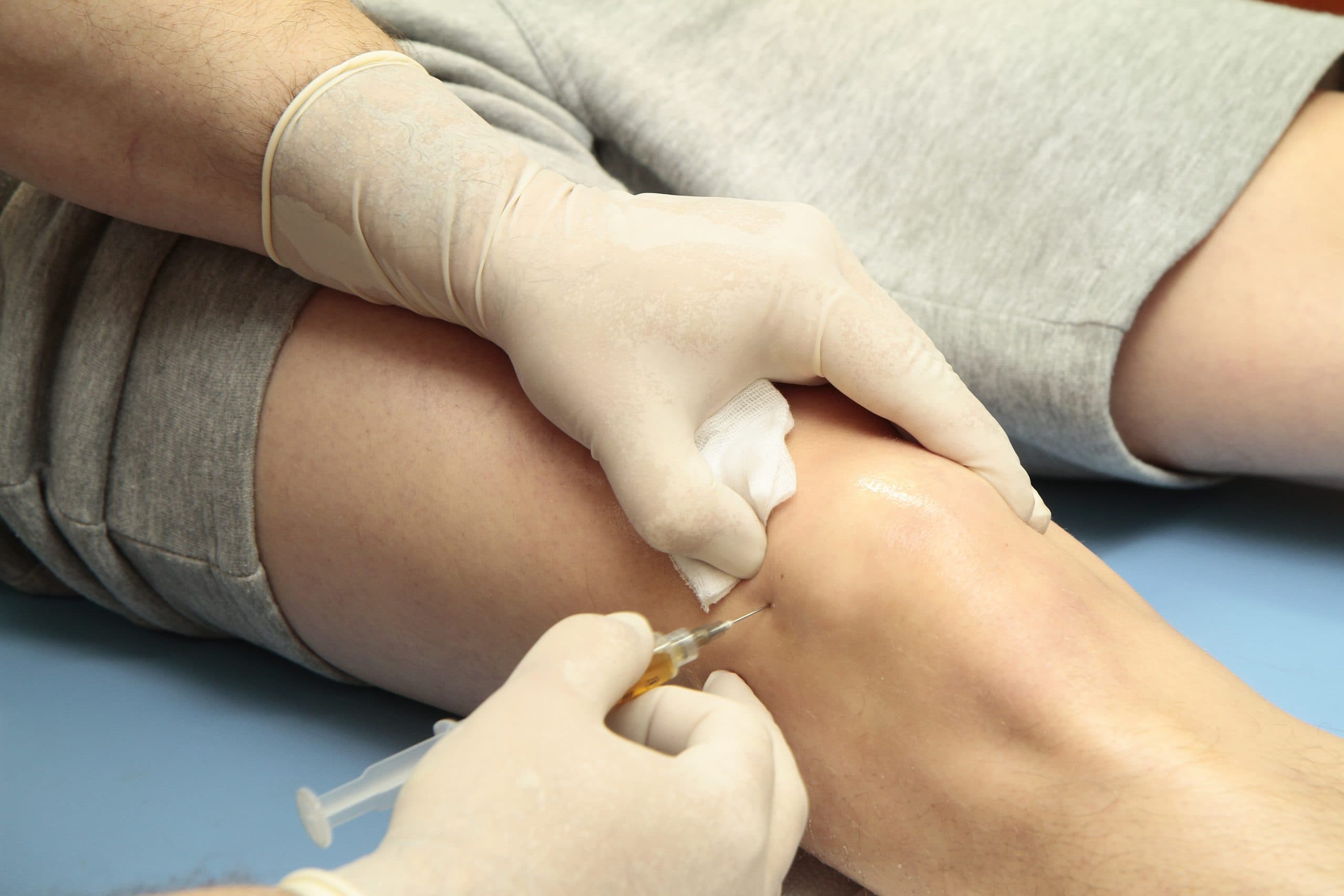 Close-up of knee assessment and treatment