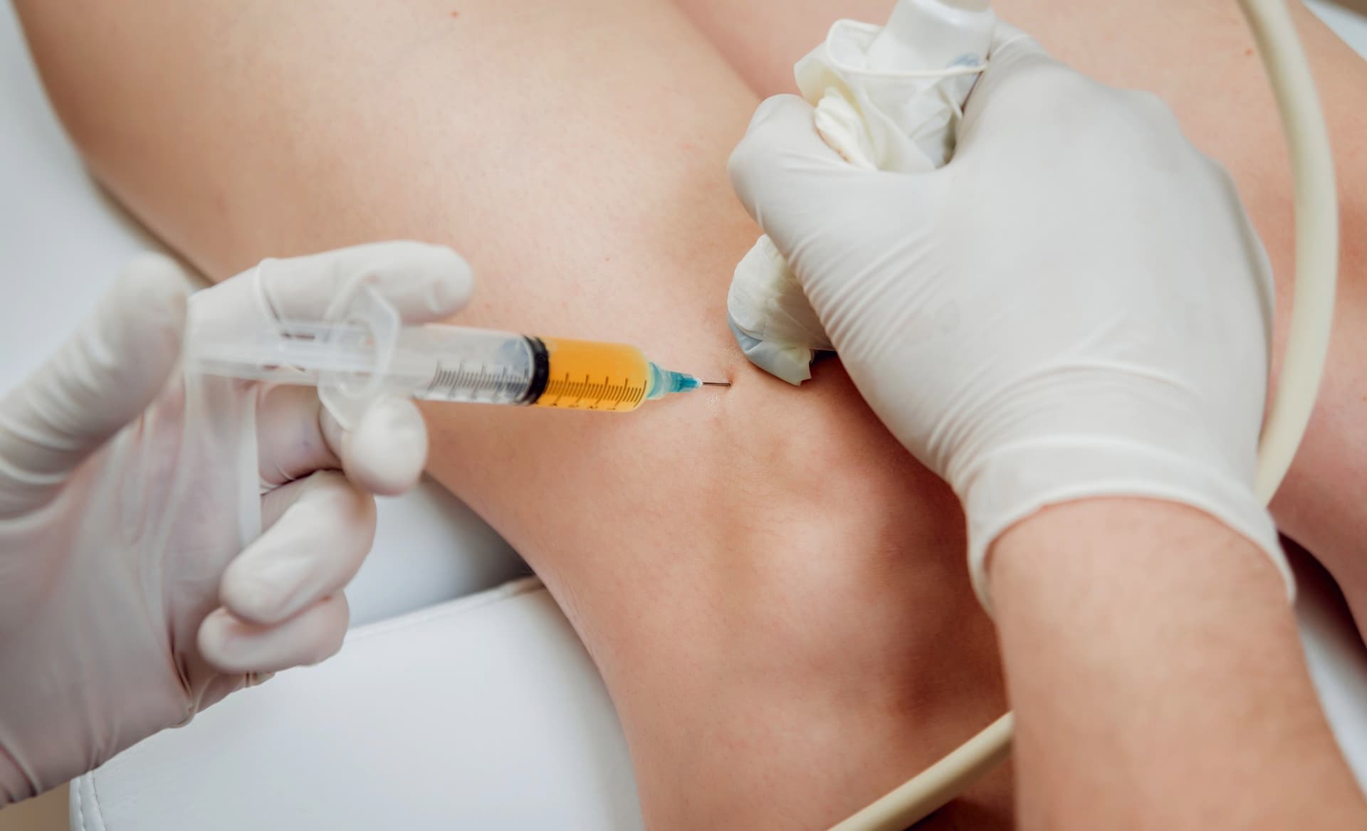 Ultrasound-guided knee injection demonstrating precision technique